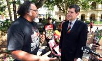 Adrian Burragubba of the Wangan and Jagalingou people talks to Queensland’s speaker Peter Wellington before presenting him with a declaration of defence of country in Brisbane