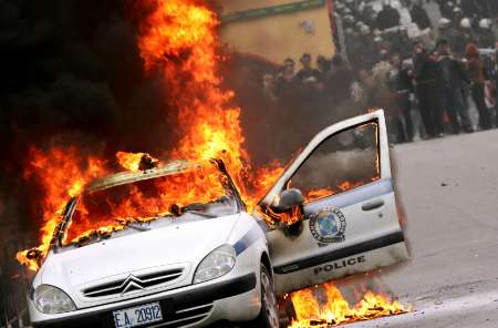 burning copcar in greece.jpg