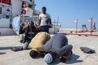 Gambian migrants celebrate arriving in Italy, unaware of what is likely to follow. (Jason Florio/MOAS/IRIN)
