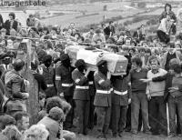 Masked I.R.A. members carry the coffin of Martin Hurson, died after 46 days on hunger strike. Galbally. Ireland (july, 1981)