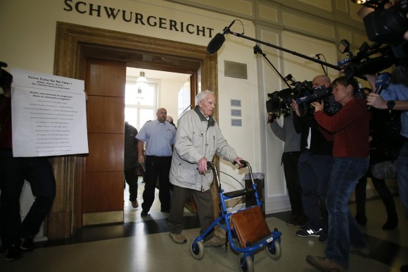 Bruins, a suspected Nazi war criminal, leaves a courtroom after his trial