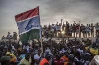 People celebrating freedom - the New Gambia and the old flag